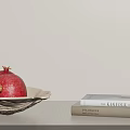 Fresh Ripe Pomegranates in White Bowl with KINFOLK and BRIDES Books