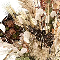 Natural Dried Flower Arrangement In Green Glass Vase With Beige Brown Blooms And Leaves