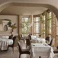 Elegant Restaurant Interior With Arched Doorway Large Windows Dining Tables White Tablecloths And Plants