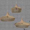 Three Minimalist Modern Woven Pendant Lights With Dome Shaped Design Hanging On Light Colored Wall