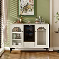 White Tea Cabinet With Glass Doors And Decorative Items On Top With Green Wall Background