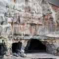 Vibrant Garden Landscape With Rocky Cliffs Natural Caves And Sandy Ground Textures