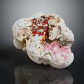 Natural White Stone With Red And Pink Inclusions And Detailed Textured Surface