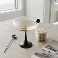 Elegant Martini Glass With Silver Spoon White Decorative Balls On Light Tabletop By Window