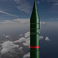 Green Missile Flying With Rocket Exhaust Over Ocean And Land Under Cloudy Sky