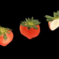 Fresh Ripe Juicy Strawberries Two Whole Red And One Sliced Half On Black Background