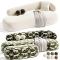 Beige And Green Tiger Patterned Irregular Shaped Sofa With Round Cushions And Plaid Blanket