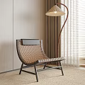 Woven Leisure Chair with Black Metal Frame by Light Wooden Wall and Floor Lamp