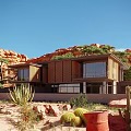 Modern Detached Villa in Desert Rocky Landscape with Large Windows Terrace and Greenery