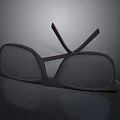 Stylish Black Rectangular Glasses With Red Accent Temple Arms Placed On Dark Reflective Surface