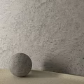 Textured Gray Wall With Gray Sphere On Light Colored Countertop Surface