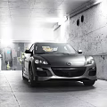 Black Mazda Sports Car Parked In Industrial Style Tunnel With Concrete Walls And Lighting