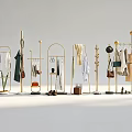 Stylish Clothes Display with Gold Racks Hanging Dresses Shirts and Accessories