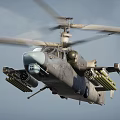 Military Helicopter With Rotors Mounted Weapons Gray Fuselage And Light Blue Nose On Ground