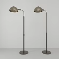 Two Metallic Floor Lamps With Sleek Design Round Shades And Tall Stands