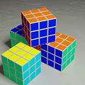Colorful Rubik's Cubes Stacked With Vibrant Multicolored Faces On Gray Surface