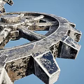 Large Metallic Gears in Industrial Equipment with Blue Sky and Ocean Background