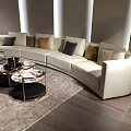 Curved White Sectional Sofa with Mixed Pillows and Round Coffee Tables in Modern Living Room