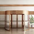 Brass Frame Revolving Door With Glass Panels Wooden Floor And Green Plant
