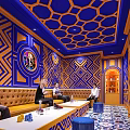 KTV Interior With Blue And Orange Geometric Patterns Sofa TV And Group Gathering Area