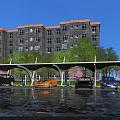 Outdoor Parking Canopy with Cars Parked Under Green Trees and Pink Flowers Near Residential Building