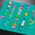 Colorful Marine Creature Models Display On Teal Tray With Various Shapes And Colors