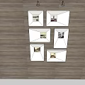 Six Framed Wall Art Paintings Arranged in Gallery Style on Wooden Floor Background