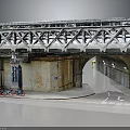 Urban Steel Truss Bridge With Concrete Support Underpass Bicycles And Water Reflection