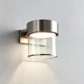 Modern Stainless Steel Wall Lamp with Glass Shade and Soft Lighting Mounted on White Wall