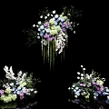 Elegant Hanging Vase Flower Arrangements With White Purple Blue Blooms And Green Leaves