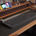 Wireless Computer Keyboard On Wooden Desk With Game Controller And Mouse