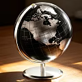 Silver Black Globe with Metal Stand on Wooden Table Under Sunlight