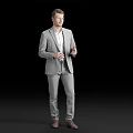 Man Standing in Gray Suit With White Shirt Against Black Background