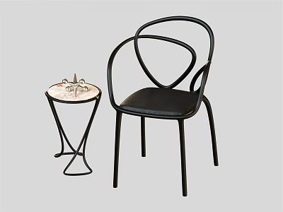 Modern Black Leather Leisure Chair With Curved Metal Backrest Side Table And Decorative Ornament 3d model