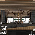 Starbucks Coffee Round Building With Wooden Panels Outdoor Seating Green Umbrellas And Stone Pavement