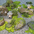 Green Plants With Moss Covered Stones And Small Lanterns In Zen Gravel Garden