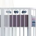 Cozy White Baby Crib with Curved Rails and Pink Purple Quilts Plus White Canopy