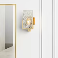 Bathroom Sink with Gold Framed Mirror Brass Faucet and Wall Sconces on White Wall