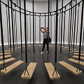 Art Installation With Circular Black Ropes Wooden Platforms And Visitor Interaction