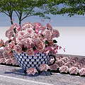 Blue And White Teacup Planter With Pink Roses Surrounded By Trees And Small Flowers