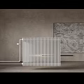 White Vertical Radiator for Home Heating in Room with Gray Wall and Decorative Art