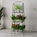 Multi tiered Metal Plant Stand With Various Green Plants And Indoor Decor