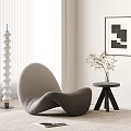 Gray Lounge Chair with Side Table Vase Green Plant and White Spiral Decorative Column
