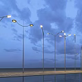 Modern Outdoor Lights with Curved Metal Poles and Water Reflection Under Cloudy Night Sky