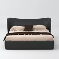 Double Bed with Black Curved Headboard Light Colored Mattress White Pillows Brown Cushion and Blanket