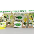 Exhibition Booths With White Canopies Green Yellow Decorations Plants And Circular Central Area