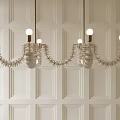 Modern Unique Design Chandeliers Featuring Multiple Lights Hanging On White Paneled Wall