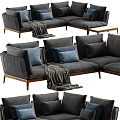 Gray Sectional Sofa With Blue Pillows Throw Blanket And Wooden Legs