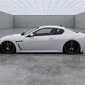 White Maserati Coupe With Sleek Exterior Design And Black Alloy Wheels In Modern Indoor Space
