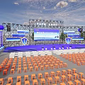 Large Outdoor Event Venue With Stage Setup Orange Chairs Blue Banners And Decorations